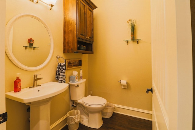 6923 Saint Anthony Dr, Tyler, TX 75703 - half bathroom featuring toilet and wood finished floors