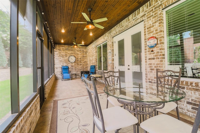 6923 Saint Anthony Dr, Tyler, TX 75703 - sunroom featuring brick wall, a ceiling fan, wood ceiling, and french doors