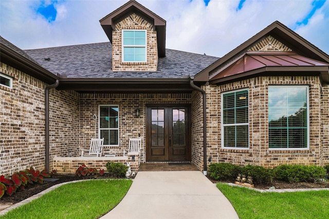 6923 Saint Anthony Dr, Tyler, TX 75703 - entrance to property with french doors, brick siding, and roof with shingles