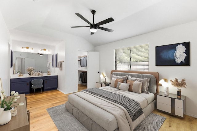 6325 Brookhaven Trl, Fort Worth, TX 76133 - bedroom with a spacious closet, vaulted ceiling, light wood-style floors, connected bathroom, and ceiling fan