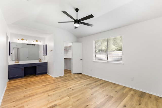 6325 Brookhaven Trl, Fort Worth, TX 76133 - unfurnished bedroom with light wood-style flooring, vaulted ceiling, connected bathroom, a walk in closet, and a ceiling fan