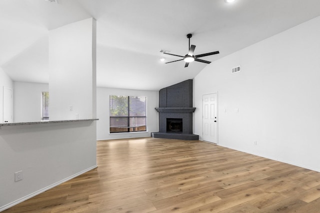 6325 Brookhaven Trl, Fort Worth, TX 76133 - unfurnished living room with vaulted ceiling, a ceiling fan, a brick fireplace, light wood-type flooring, and recessed lighting