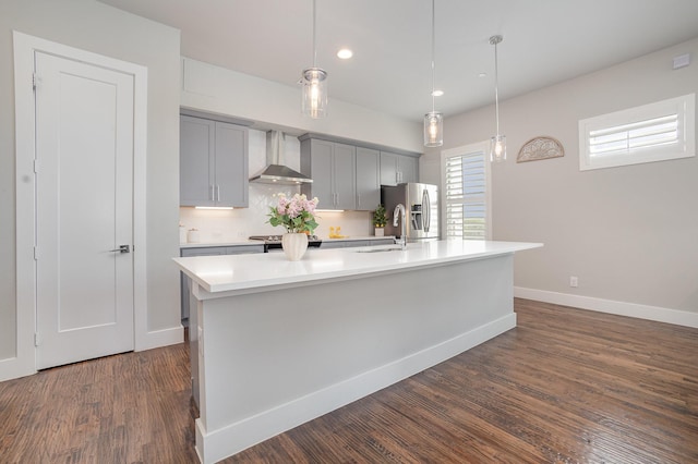770 N Plano Rd Unit 202, Richardson, TX 75081 - kitchen with wall chimney range hood, gray cabinetry, stainless steel refrigerator with ice dispenser, light countertops, and an island with sink