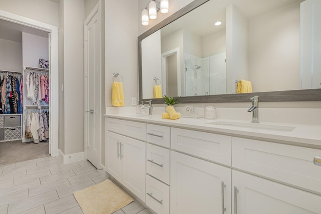 770 N Plano Rd Unit 202, Richardson, TX 75081 - bathroom with a shower stall, double vanity, a spacious closet, and recessed lighting