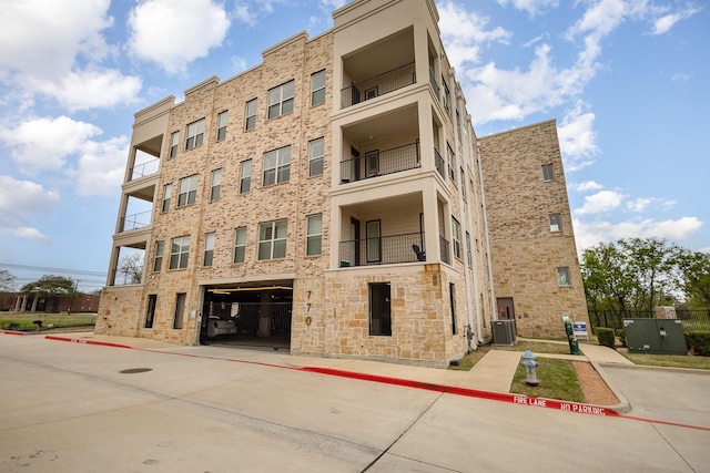 770 N Plano Rd Unit 202, Richardson, TX 75081 - view of apartment building / complex featuring an attached garage