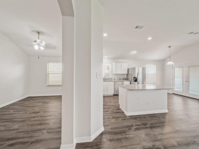 8705 Autumn Creek Trl, Fort Worth, TX 76134 - kitchen featuring stainless steel appliances, plenty of natural light, dark wood-type flooring, white cabinets, and vaulted ceiling
