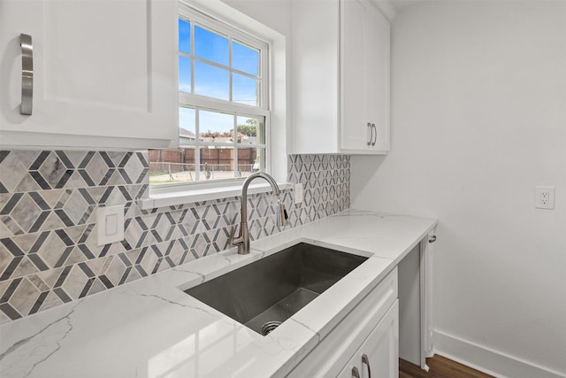 2511 Gregory Dr, Mesquite, TX 75150 - kitchen with backsplash, white cabinetry, and light stone counters