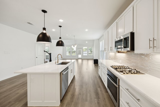 2819 Grand Lookout Ln, Arlington, TX 76001 - kitchen featuring stainless steel appliances, wood finished floors, recessed lighting, tasteful backsplash, and white cabinets
