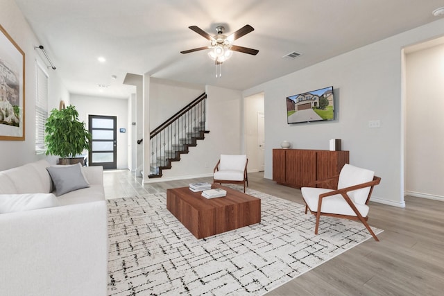 18137 Lakefront Ct, Forney, TX 75126 - living room featuring ceiling fan, light wood finished floors, and stairs