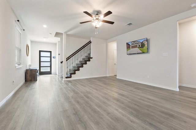 18137 Lakefront Ct, Forney, TX 75126 - foyer entrance featuring a ceiling fan, wood finished floors, and stairs