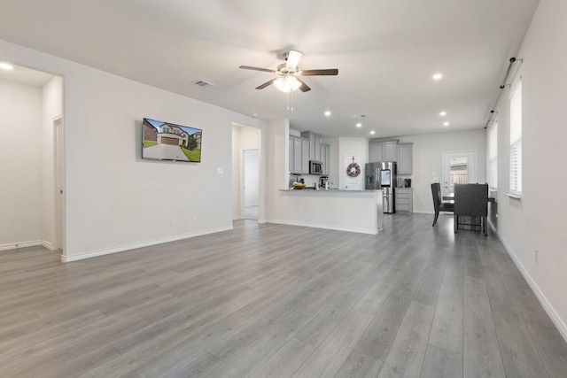 18137 Lakefront Ct, Forney, TX 75126 - unfurnished living room with ceiling fan, light wood finished floors, and recessed lighting