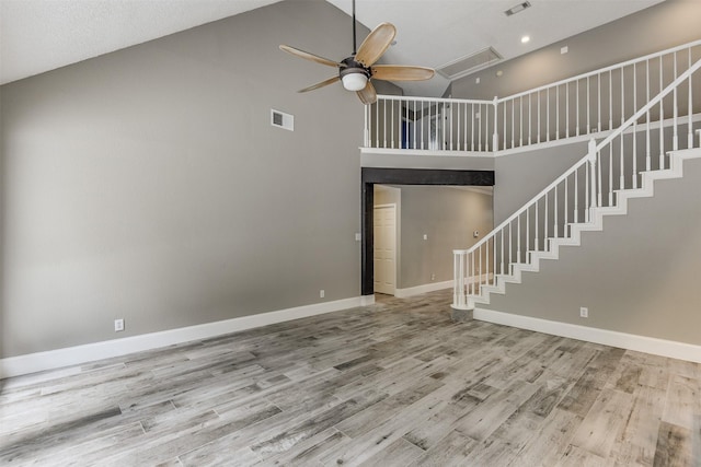 6111 Pinwood Cir, Arlington, TX 76001 - unfurnished living room featuring high vaulted ceiling, a ceiling fan, wood finished floors, stairs, and attic access