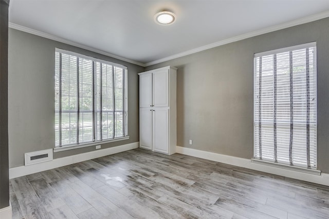6111 Pinwood Cir, Arlington, TX 76001 - unfurnished bedroom featuring crown molding and light wood-style flooring