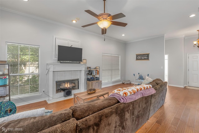 118 Otto Ln, Shreveport, LA 71105 - living area with ceiling fan, wood finished floors, crown molding, a tiled fireplace, and recessed lighting