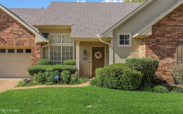 118 Otto Ln, Shreveport, LA 71105 - view of exterior entry featuring an attached garage, brick siding, a lawn, and a shingled roof