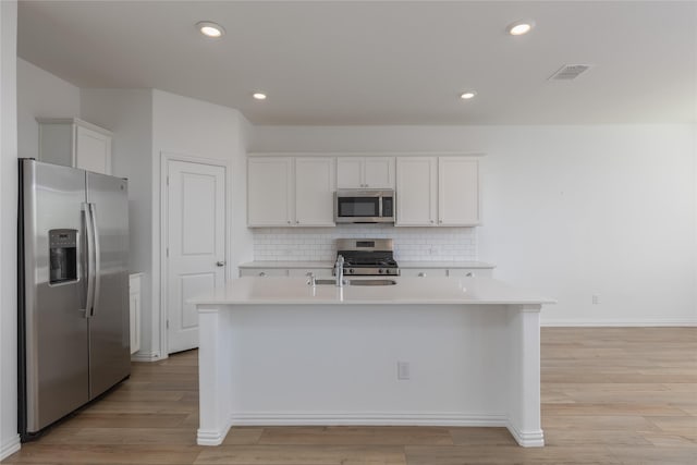 204 Post Oak St, Azle, TX 76020 - kitchen with stainless steel appliances, light countertops, decorative backsplash, white cabinets, and a kitchen island with sink