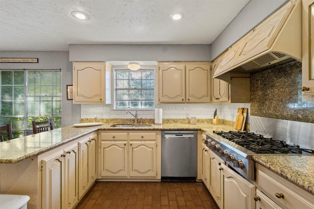 1605 Lamberth Cir, Sherman, TX 75092 - kitchen featuring stainless steel appliances, premium range hood, backsplash, a peninsula, and brick patterned floors
