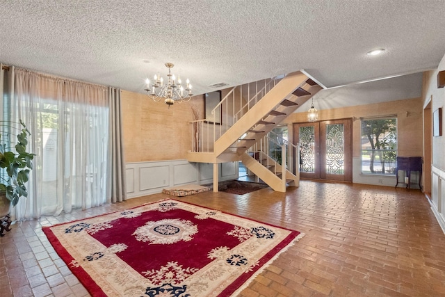1605 Lamberth Cir, Sherman, TX 75092 - foyer with a chandelier, stairway, a decorative wall, brick flooring, and plenty of natural light