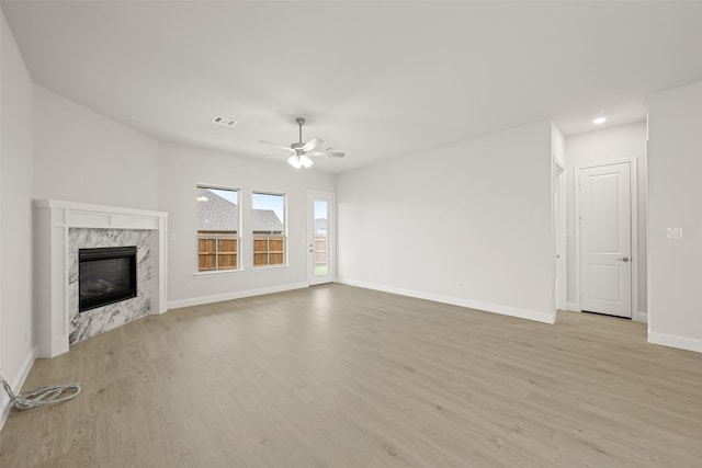 2297 High Plain Ln, Waxahachie, TX 75167 - unfurnished living room featuring light wood finished floors, a ceiling fan, a premium fireplace, and recessed lighting