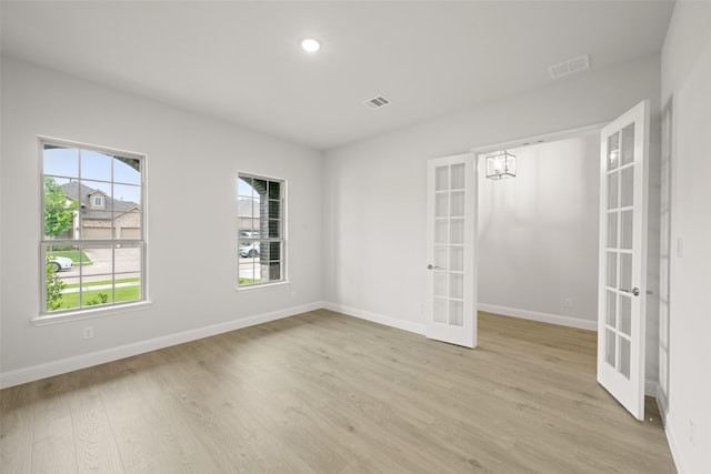 2297 High Plain Ln, Waxahachie, TX 75167 - spare room featuring french doors, light wood-style flooring, and recessed lighting