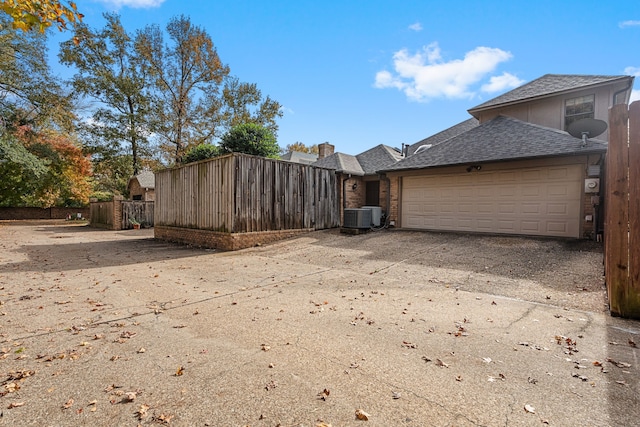 505 Buckingham Pl, Tyler, TX 75701 - view of home's exterior featuring concrete driveway, brick siding, an attached garage, and a shingled roof