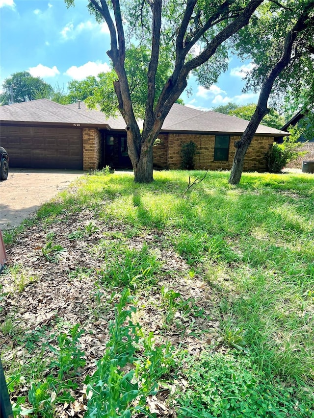 4720 Michelle Dr, Arlington, TX 76016 - view of front facade featuring concrete driveway, an attached garage, and brick siding