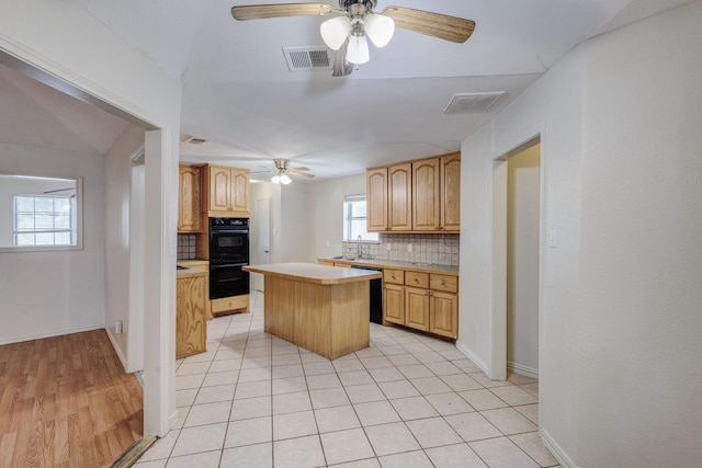 7305 Ridgeview Dr, Rowlett, TX 75089 - kitchen with ceiling fan, backsplash, light countertops, and a kitchen island