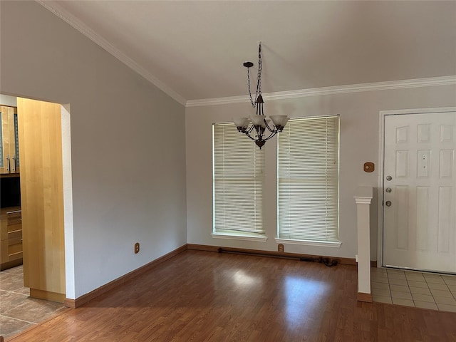 216 Lemon Dr, Arlington, TX 76018 - unfurnished dining area with crown molding, a chandelier, and wood finished floors