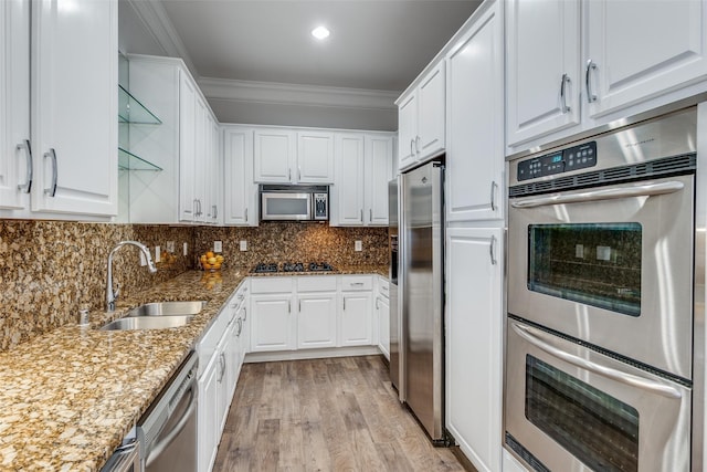 3303 Blackburn St Unit 308, Dallas, TX 75204 - kitchen with appliances with stainless steel finishes, white cabinets, crown molding, light wood finished floors, and stone counters