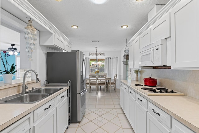 6737 Oliver Dr, North Richland Hills, TX 76180 - kitchen with white appliances, white cabinetry, light countertops, a textured ceiling, and light tile patterned flooring