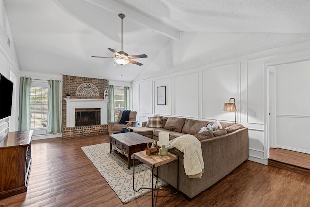 6737 Oliver Dr, North Richland Hills, TX 76180 - living room featuring a decorative wall, a ceiling fan, a brick fireplace, and dark wood-style floors
