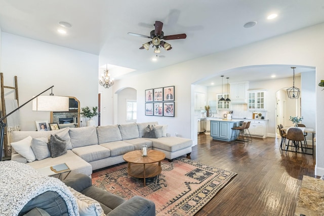 210 Walker Ct N, Waxahachie, TX 75167 - living room with arched walkways, ceiling fan, dark wood-style floors, recessed lighting, and a stone fireplace