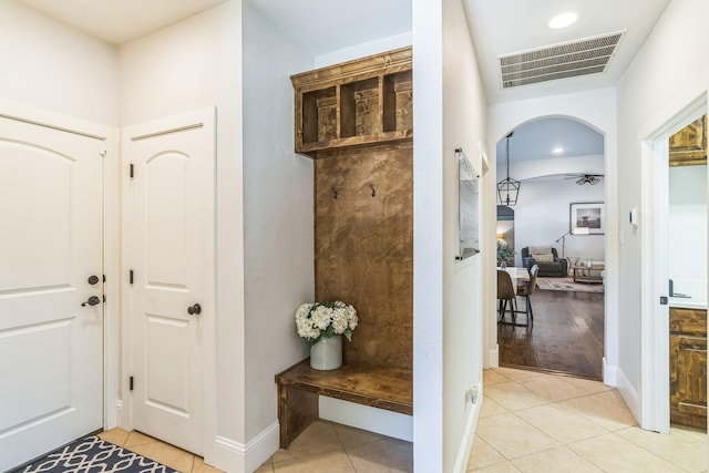 210 Walker Ct N, Waxahachie, TX 75167 - entryway with light tile patterned flooring, a ceiling fan, arched walkways, and recessed lighting