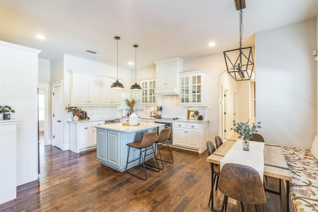 210 Walker Ct N, Waxahachie, TX 75167 - kitchen with white cabinets, a kitchen island, dark wood-style flooring, and recessed lighting