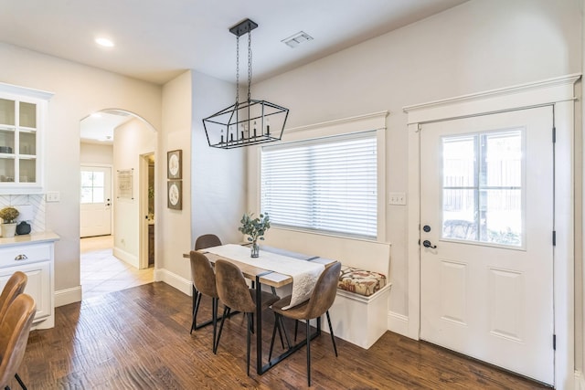 210 Walker Ct N, Waxahachie, TX 75167 - dining space with arched walkways, a chandelier, dark wood-type flooring, and recessed lighting