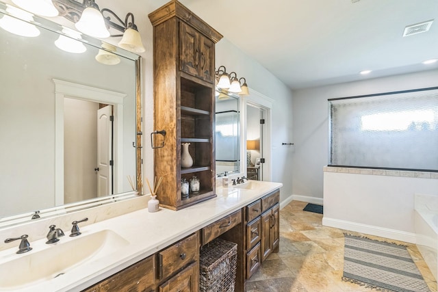 210 Walker Ct N, Waxahachie, TX 75167 - bathroom featuring double vanity, a bath, and stone finish floors