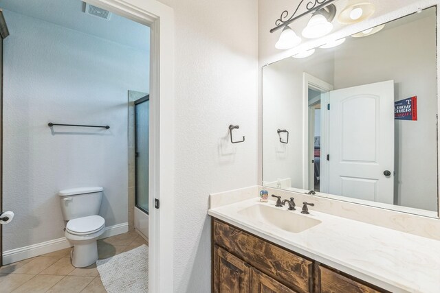 210 Walker Ct N, Waxahachie, TX 75167 - bathroom with vanity, tile patterned floors, and enclosed tub / shower combo