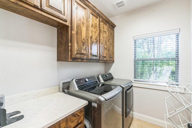 210 Walker Ct N, Waxahachie, TX 75167 - washroom featuring cabinet space, washing machine and clothes dryer, and light tile patterned floors