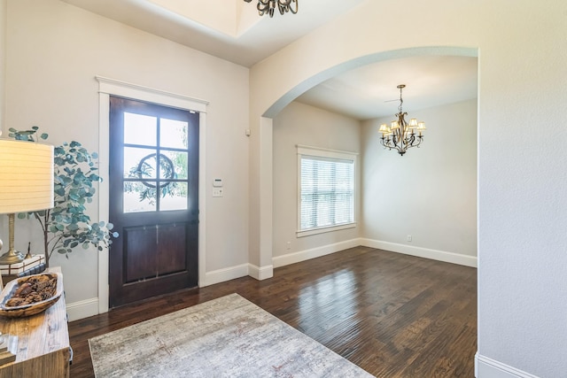 210 Walker Ct N, Waxahachie, TX 75167 - entryway with a chandelier, arched walkways, healthy amount of natural light, and dark wood-style flooring
