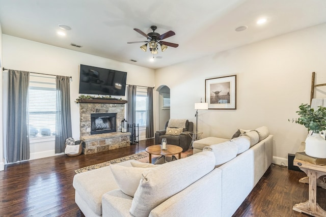 210 Walker Ct N, Waxahachie, TX 75167 - living area featuring a ceiling fan, a fireplace, wood finished floors, arched walkways, and recessed lighting