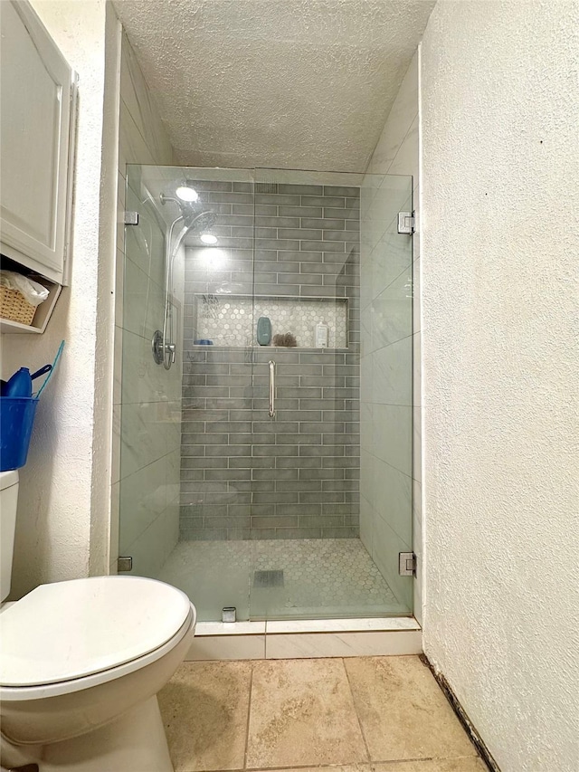 1125 Siebold Ct, Mesquite, TX 75150 - bathroom featuring a textured ceiling, a shower stall, a textured wall, and tile patterned flooring