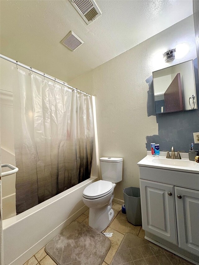 1125 Siebold Ct, Mesquite, TX 75150 - bathroom with vanity, shower / bathtub combination with curtain, tile patterned flooring, a textured wall, and a textured ceiling