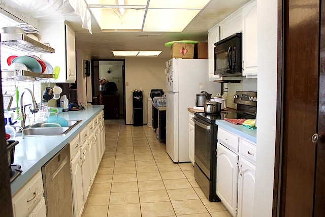 1125 Siebold Ct, Mesquite, TX 75150 - kitchen with stainless steel appliances, light tile patterned floors, white cabinets, light countertops, and open shelves
