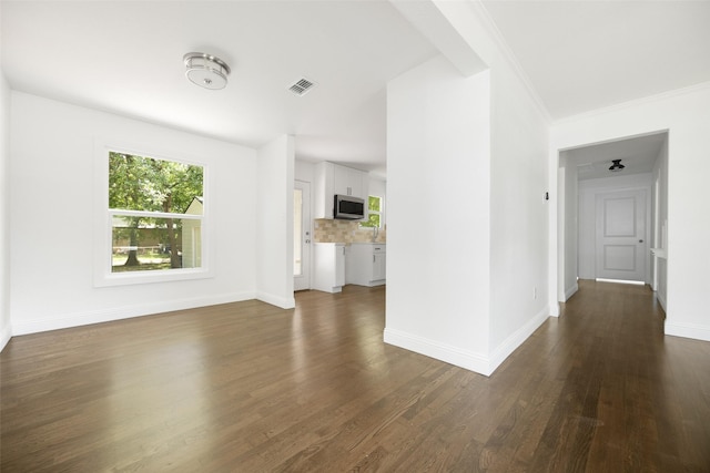 2267 Tealford Dr, Dallas, TX 75228 - unfurnished living room featuring dark wood-style floors and baseboards