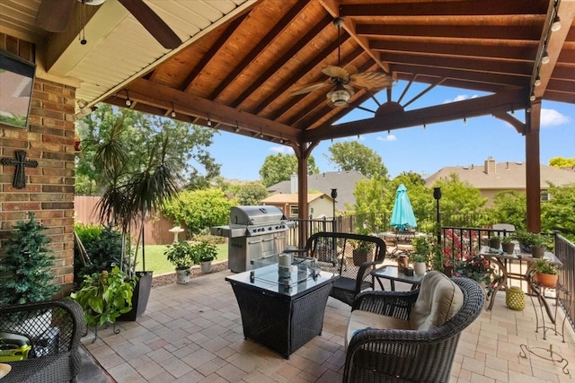 6321 Cobblestone Ln, Arlington, TX 76001 - fenced backyard featuring a ceiling fan, a patio area, a gazebo, an outdoor hangout area, and a grill