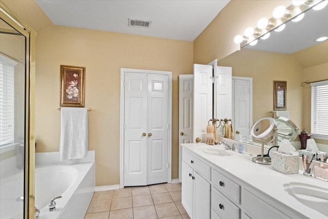 6321 Cobblestone Ln, Arlington, TX 76001 - bathroom featuring lofted ceiling, double vanity, a garden tub, tile patterned floors, and a stall shower