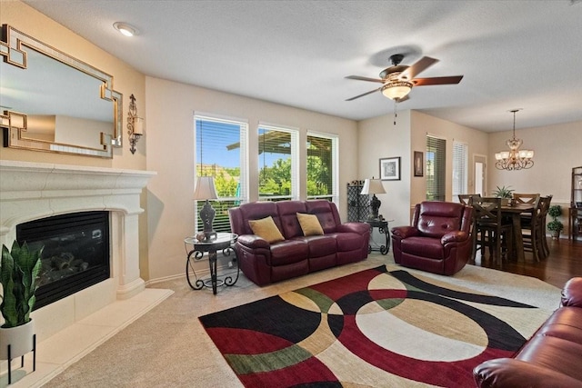 6321 Cobblestone Ln, Arlington, TX 76001 - living area featuring ceiling fan, a glass covered fireplace, a chandelier, and carpet floors