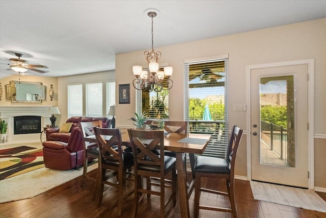 6321 Cobblestone Ln, Arlington, TX 76001 - dining space featuring wood-type flooring, a glass covered fireplace, plenty of natural light, and a chandelier