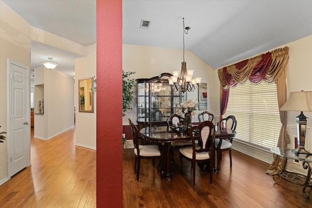 6321 Cobblestone Ln, Arlington, TX 76001 - dining area with wood finished floors, a chandelier, and lofted ceiling