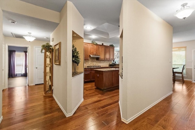 6321 Cobblestone Ln, Arlington, TX 76001 - hallway featuring dark wood-type flooring and baseboards
